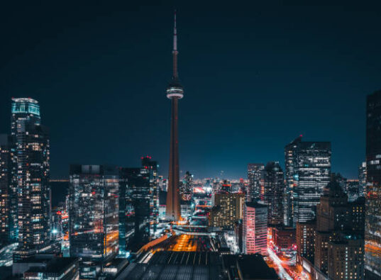 Epic futuristic and modern skyline views of downtown Toronto with the train tracks leading your eye to office buildings and condominiums.